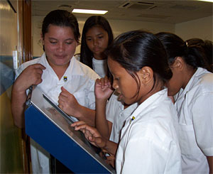 Nauruan students crowd around the new ARM educational kiosk to learn more about climate change. ARM file photo. 