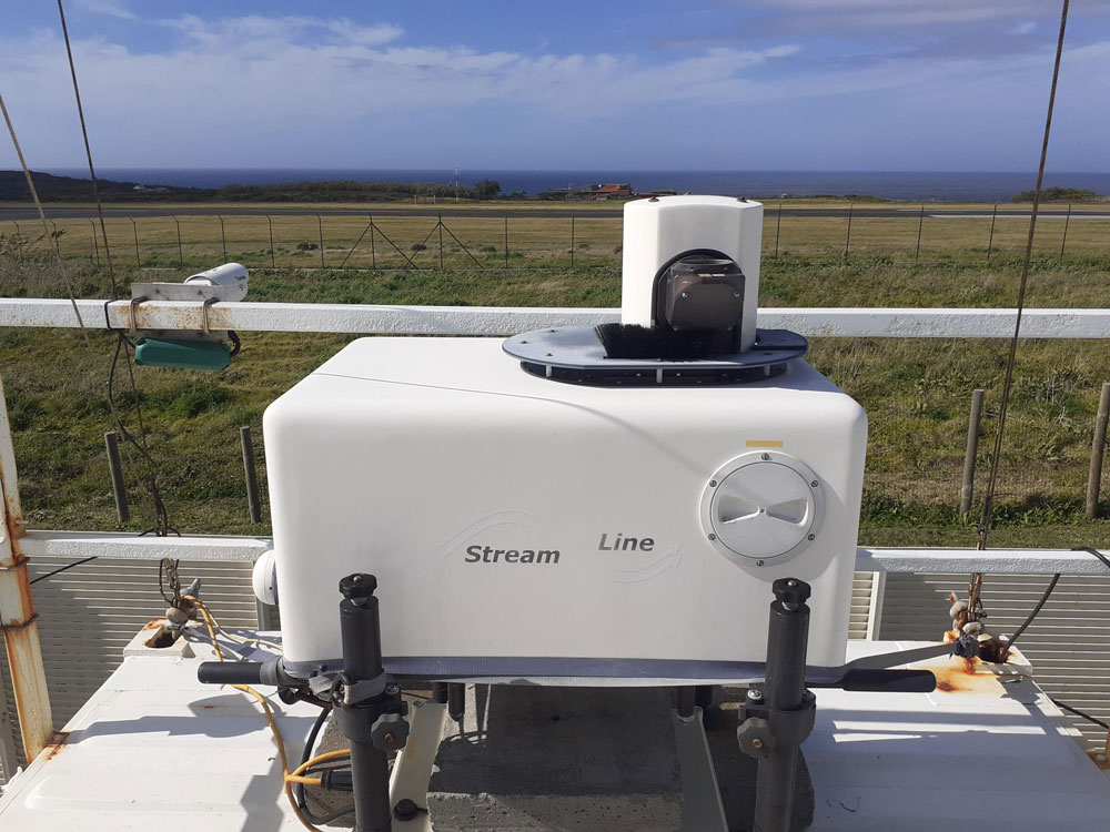 With the ocean and clouds on the horizon, a Doppler lidar operates at ARM's Eastern North Atlantic atmospheric observatory.