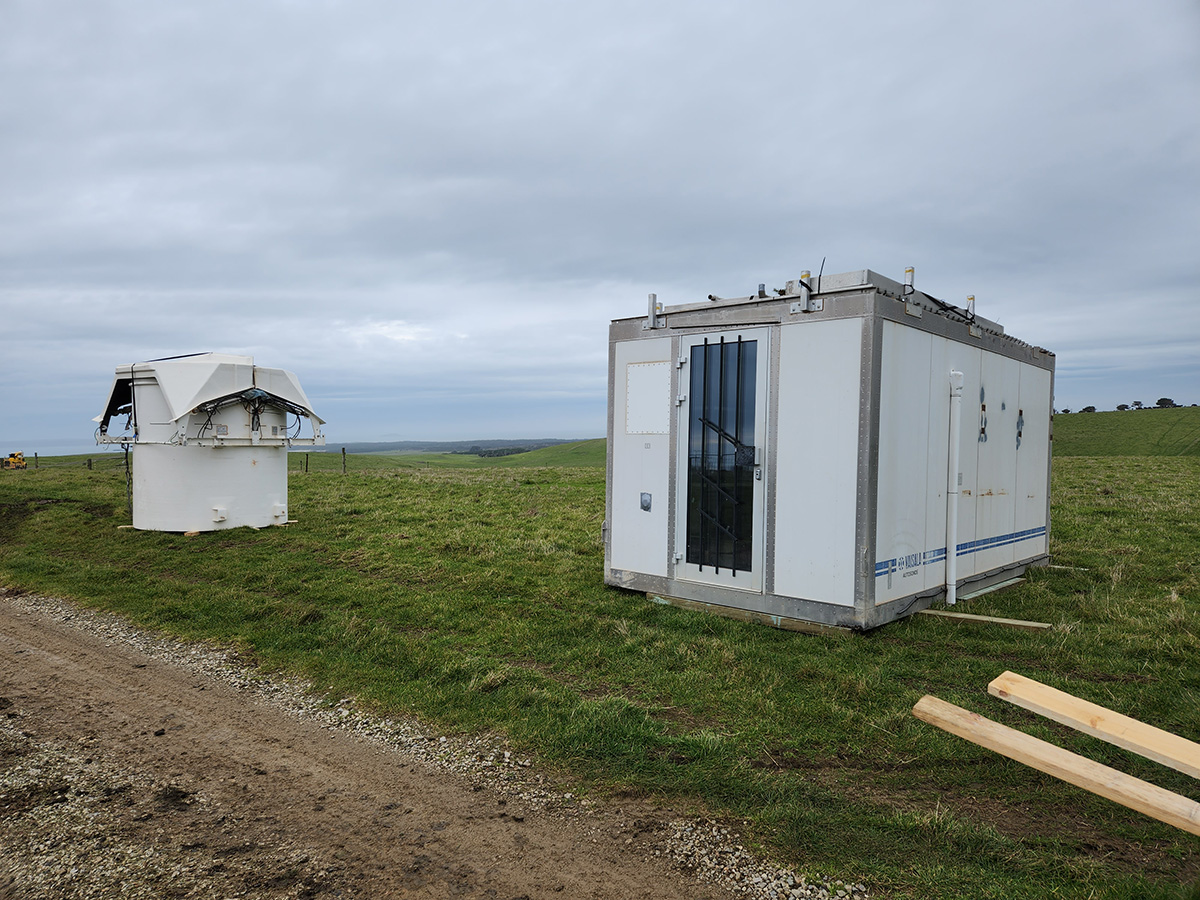 An autosonde launcher and its container are located on grass at Kennaook/Cape Grim.