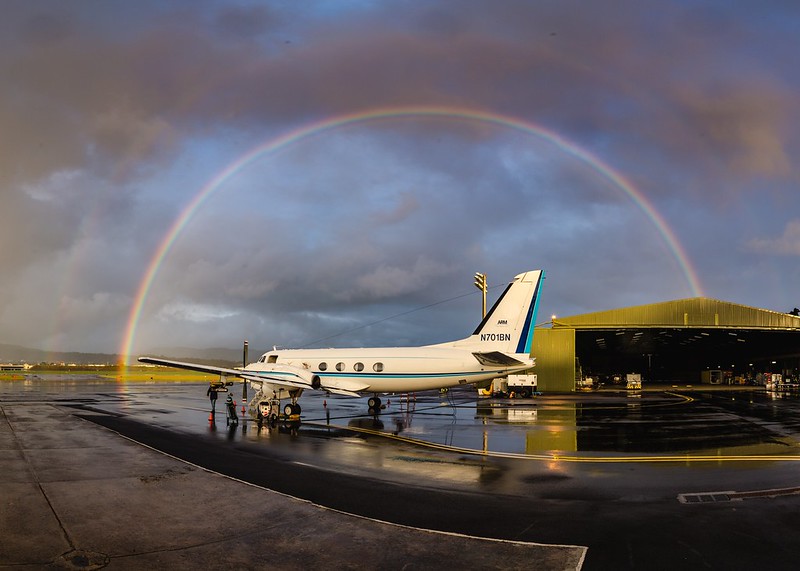A double rainbow frames the Gulfstream-159 (G-1) research aircraft on the tarmac in the Azores.