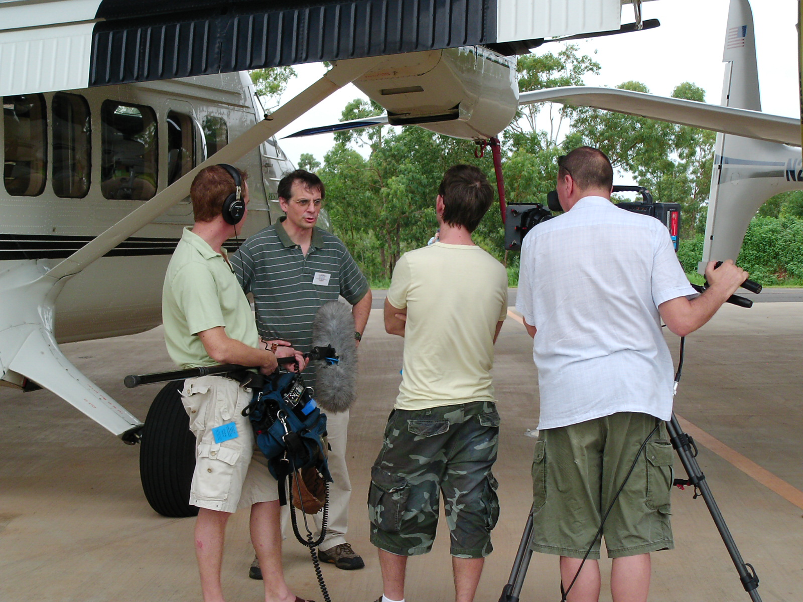 Jim Mather talks to a news crew with cameras.