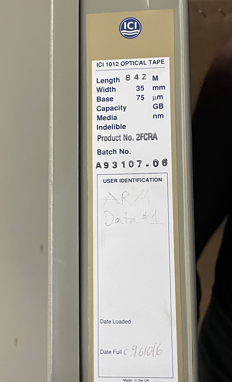 The words "ARM Data #1" faintly appear on an optical tape container label.