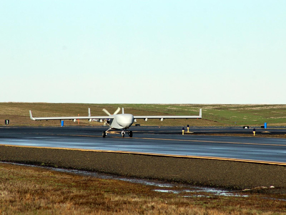 The ArcticShark uncrewed aerial system is shown on the tarmac. 