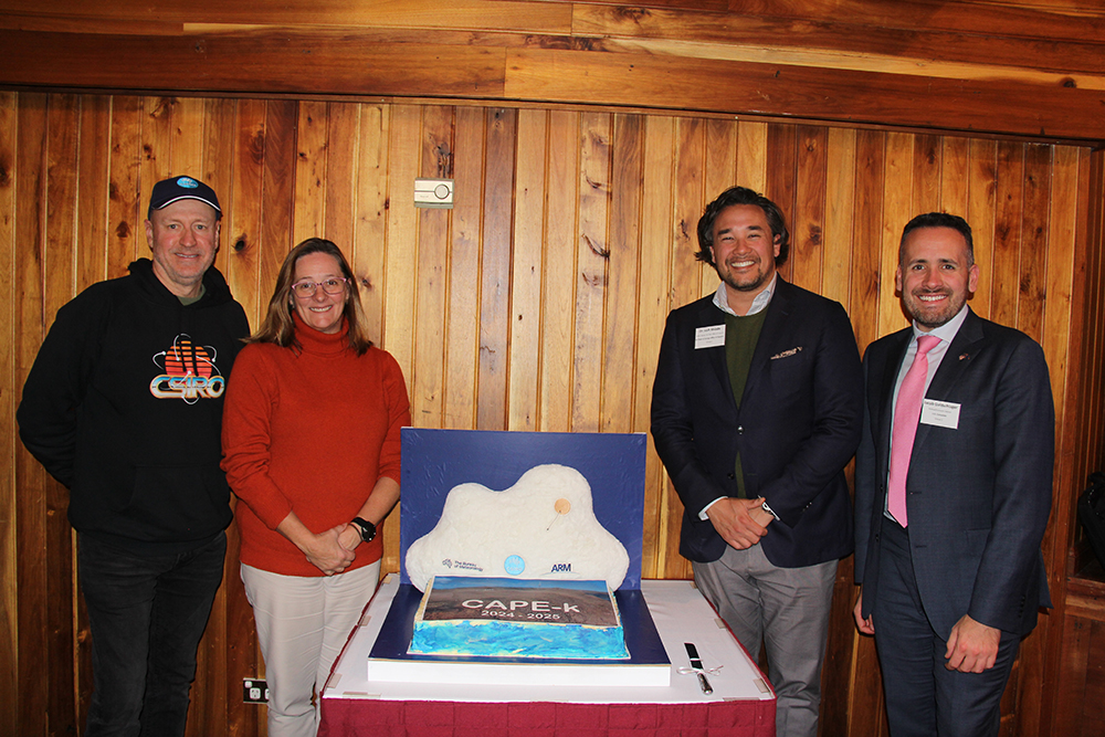 Posing next to a CAPE-k cake during the April 30, 2024, formal campaign launch event in Smithton, Tasmania, are, from left to right, Doug Hilton, CSIRO chief executive; Nichole Brinsmead, BOM chief information and technology officer and group executive, Data and Digital; Shiode; and Jacob Goldschlager, political and economic advisor for the U.S. Consulate General, Melbourne. Photo is by Sophie Schmidt, CSIRO.