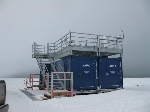 Snow surrounds the blue containers of the ARM Mobile Facility