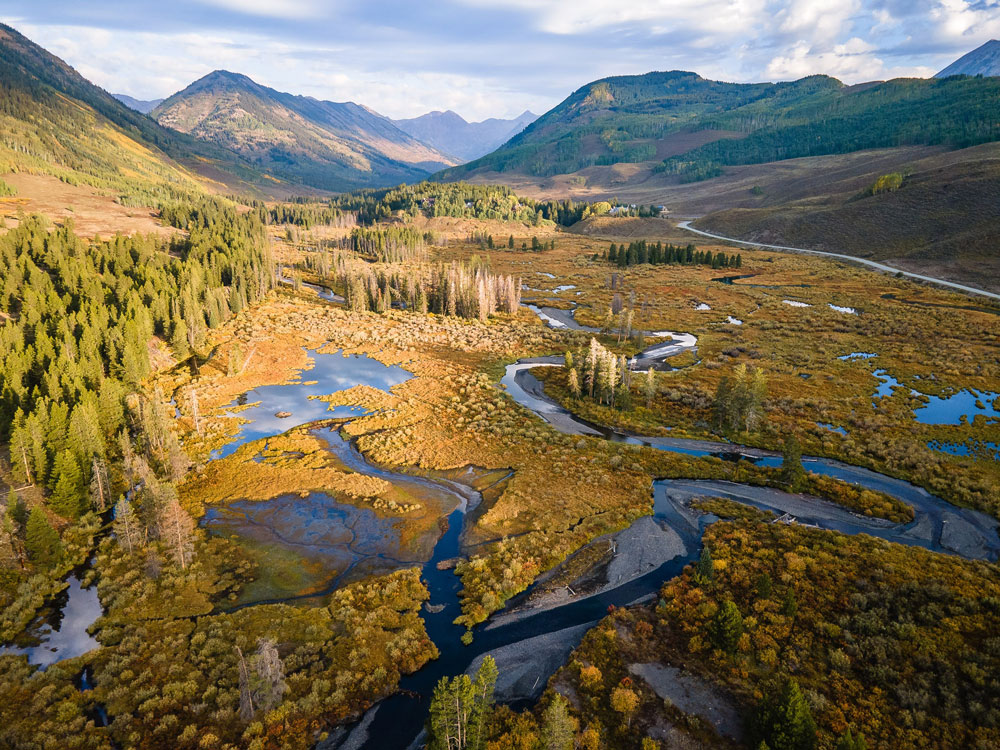 This aerial view shows water meandering through the East River Watershed in Colorado.