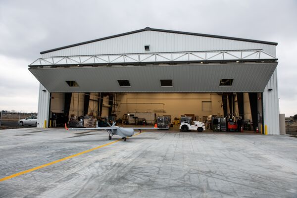ArcticShark unmanned aerial system in front of new ARM Aerial Facility hangar