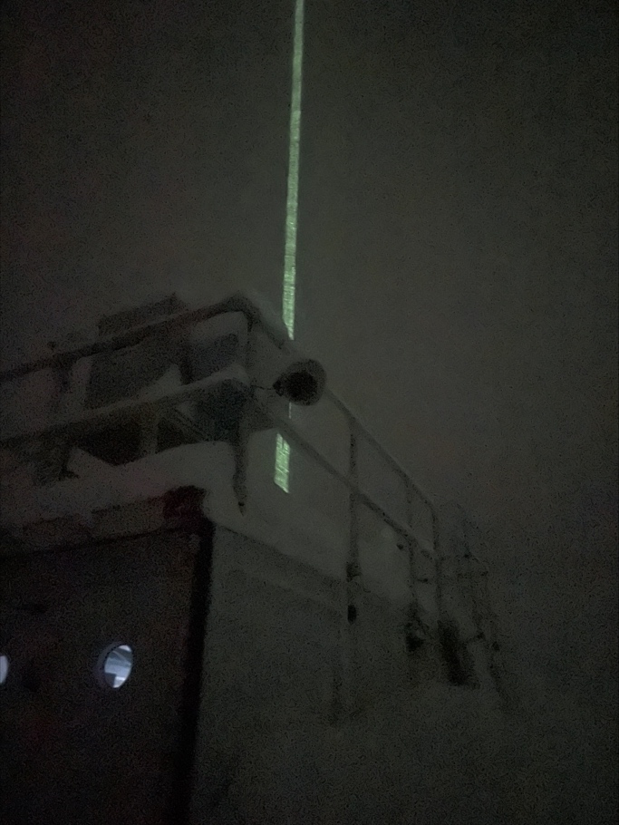 The high-spectral-resolution lidar with its vertically pointing green laser beam shooting up into the night sky