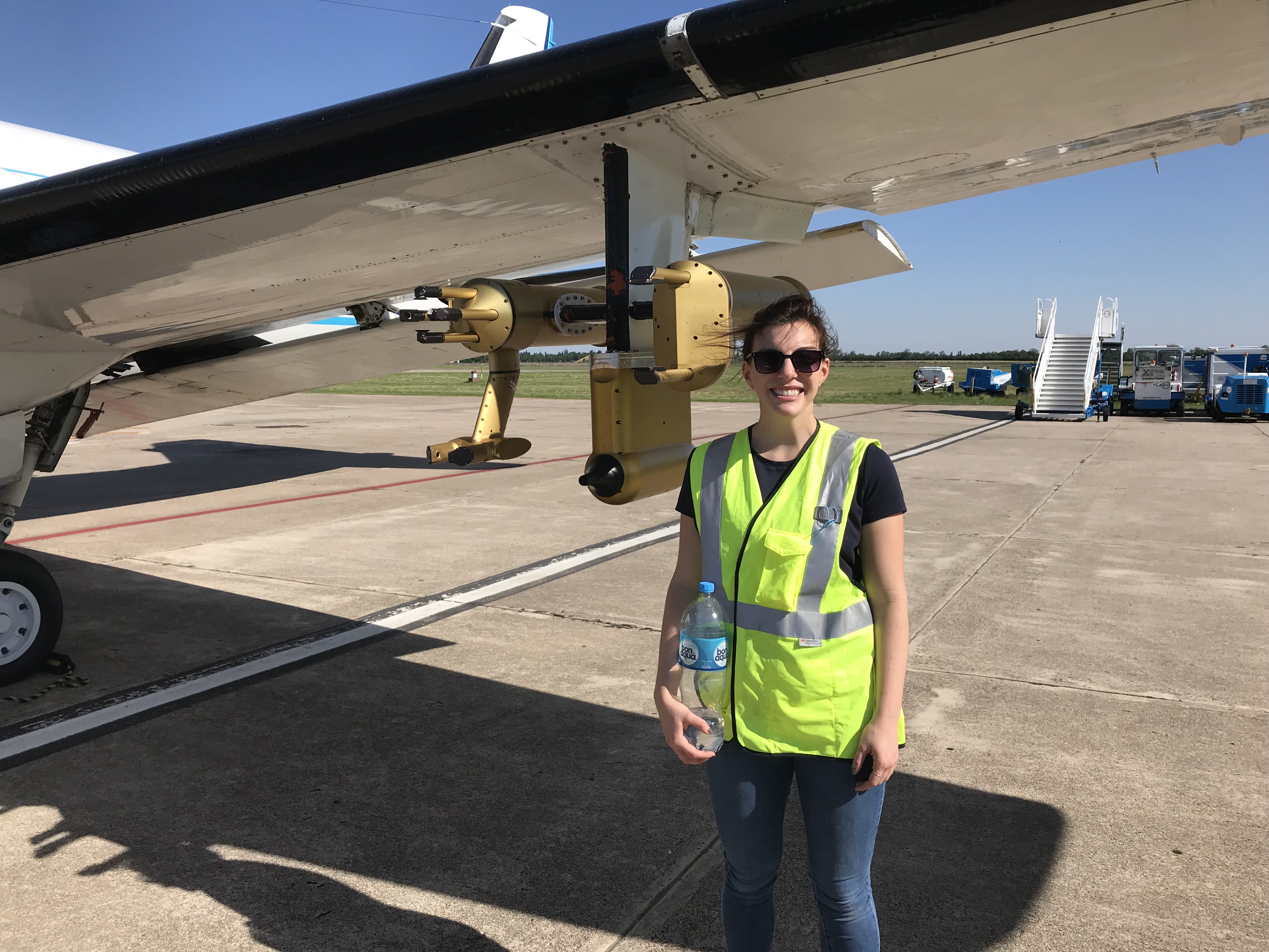 Lexie Goldberger stands next to aircraft