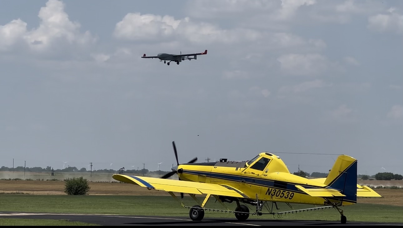 ARM’s ArcticShark uncrewed aerial system flies above a crop duster in northern Oklahoma.