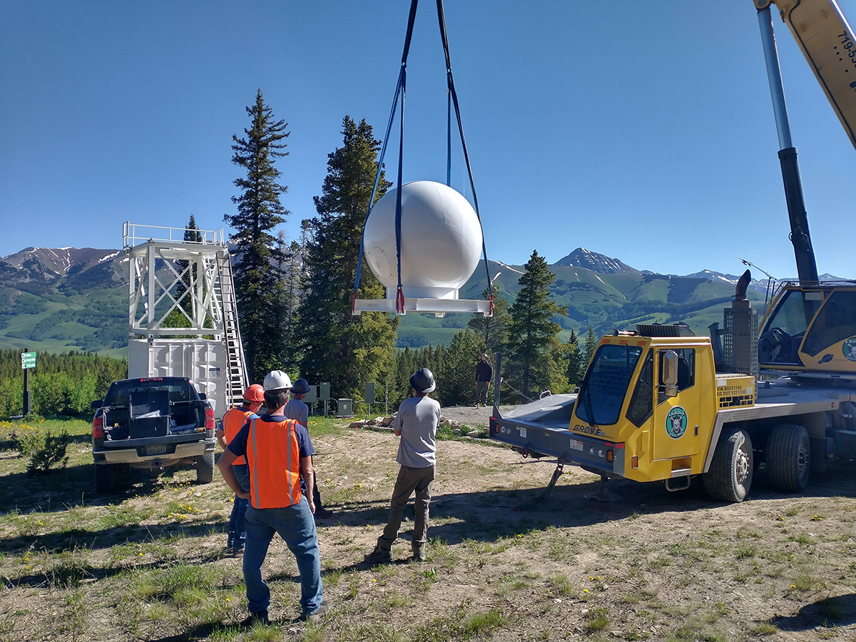 The crane continues to move the radar dome.