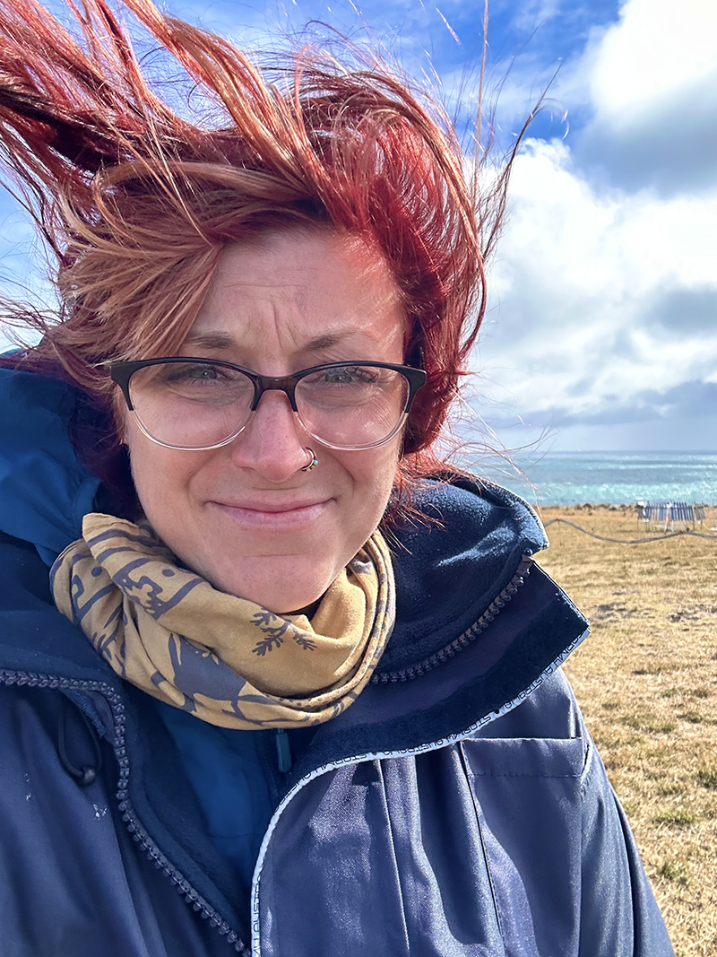 Fierce wind blows back Jessie Creamean's hair while she takes a selfie at the CAPE-k site.