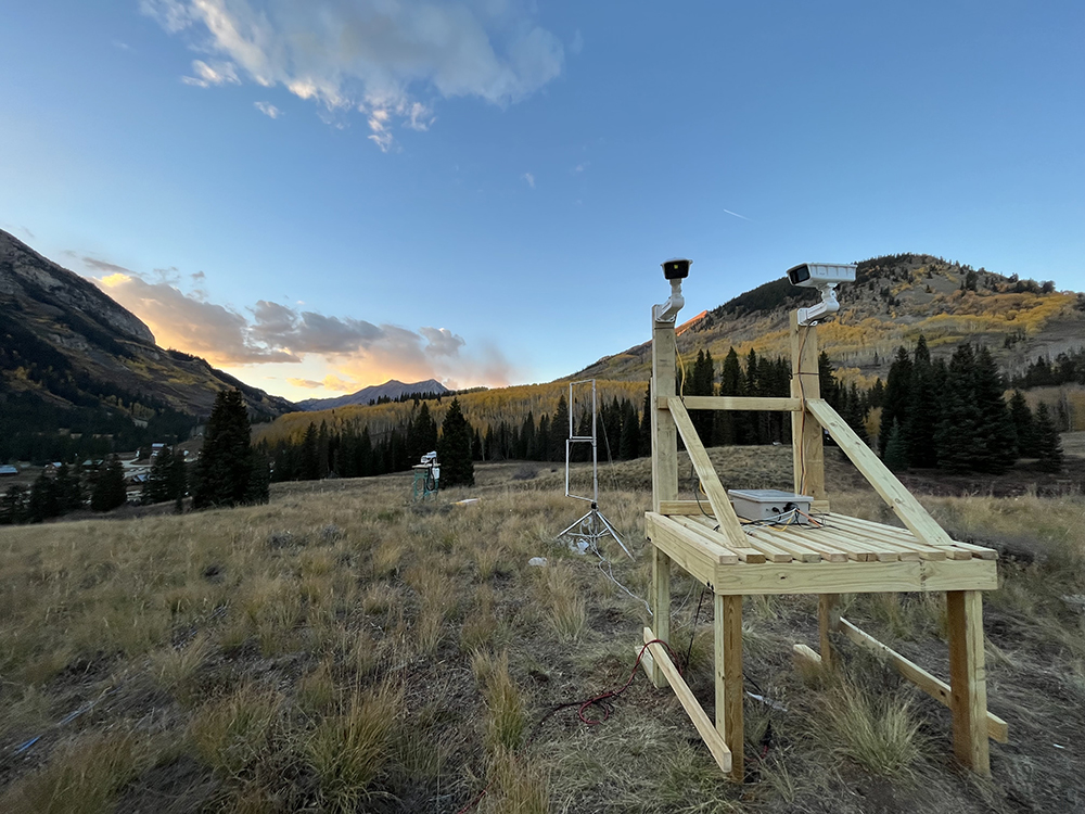 An open snowflake camera is installed on a platform close to a set of radiometers on "Instrument Hill" during the SAIL campaign in Gothic, Colorado. In this picture, it is fall, so snow has yet to appear at the site.