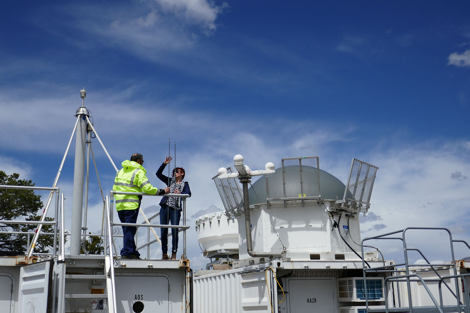 Jessie Creamean and Paul Ortega atop the Aerosol Observing System