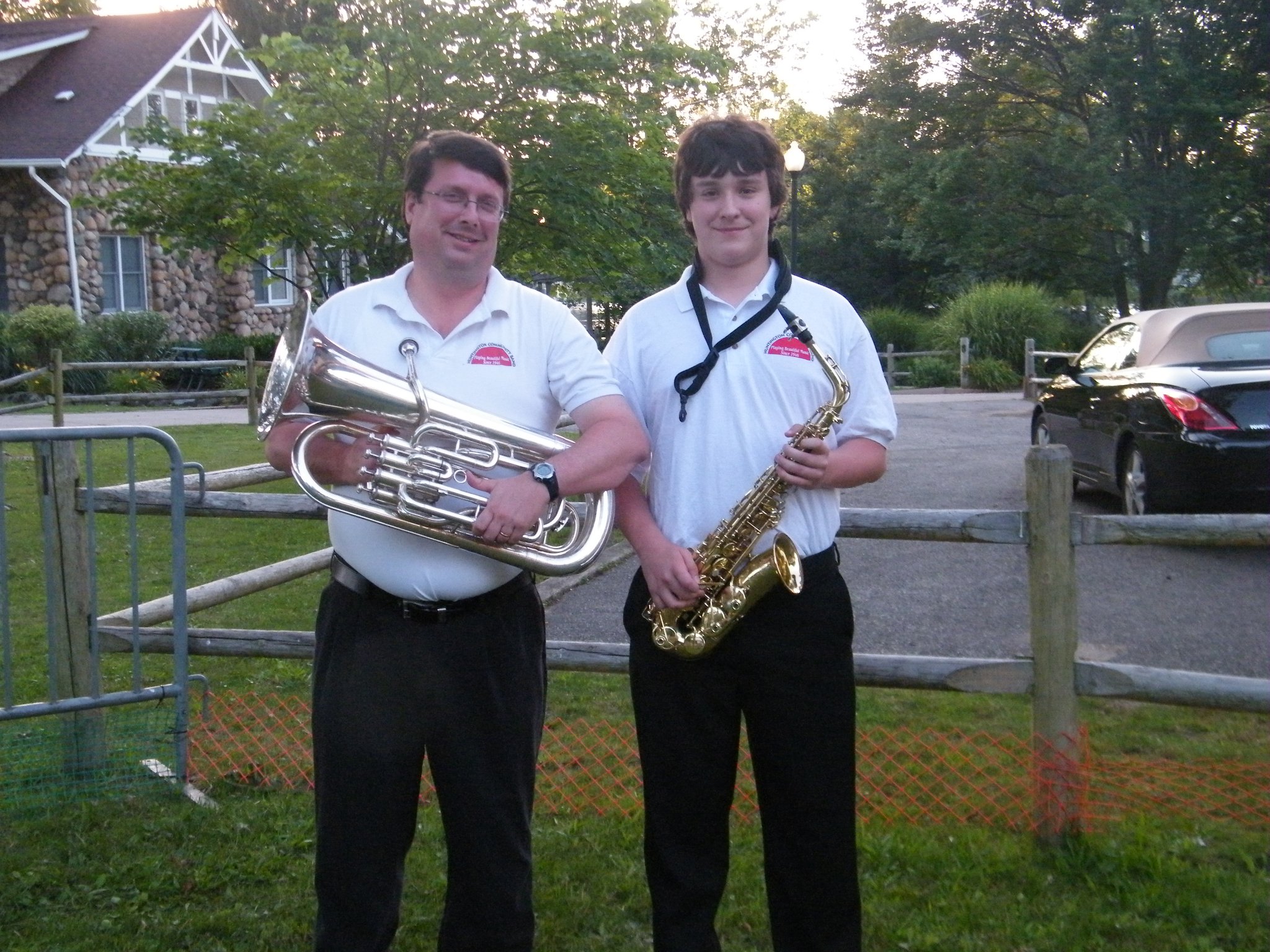 Mike Jensen and his son, Mack, pose with their musical instruments