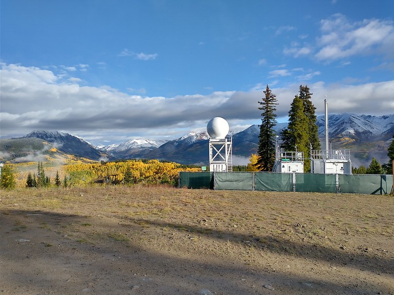 An ARM Aerosol Observing System (right) and a Colorado State University X-band precipitation radar operated side by side on Crested Butte Mountain during SAIL. 