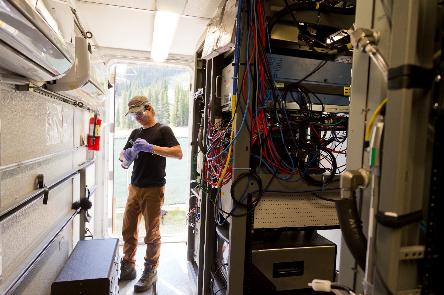 ARM technician Frank Zurek works inside an ARM Mobile Facility container.