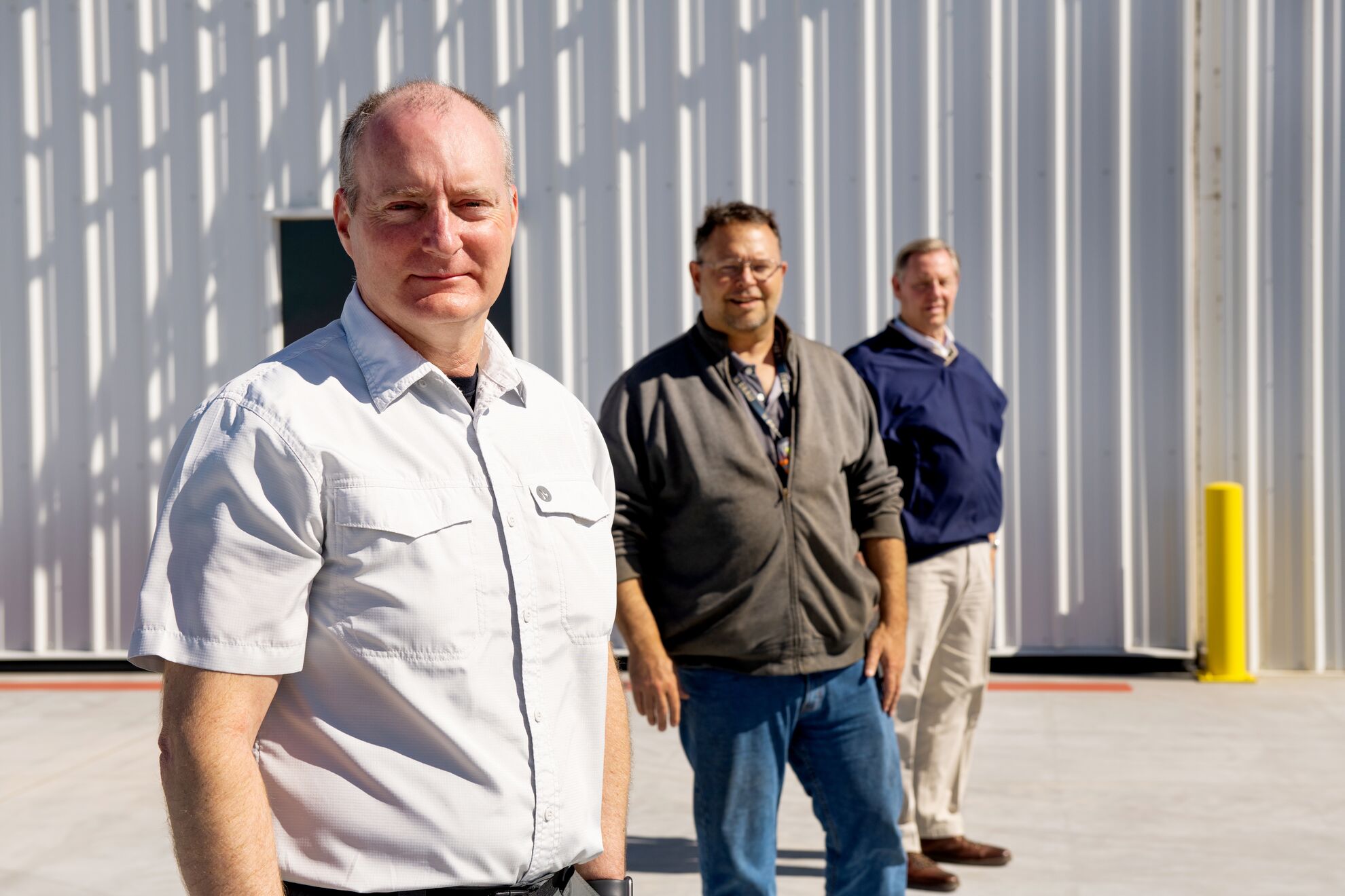 ARM Aerial Facility pilots Tim McLain, Mike Hubbell, and Jonathan Ray stand outside for a picture