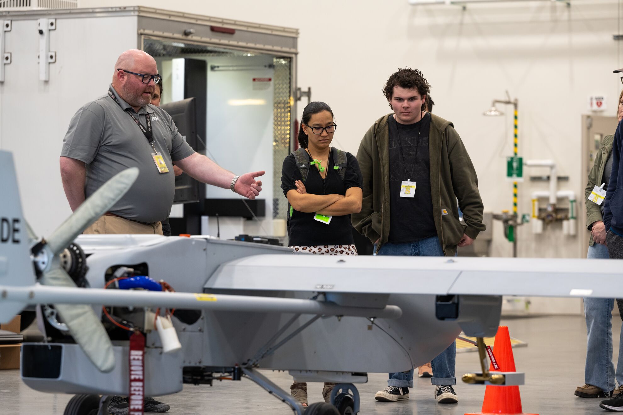 Pete Carroll, the uncrewed aerial system operations lead for the ARM Aerial Facility, shows the payload bay of the ArcticShark to a Blue Mountain Community College instructor and student. Photo is by Andrea Starr, Pacific Northwest National Laboratory.