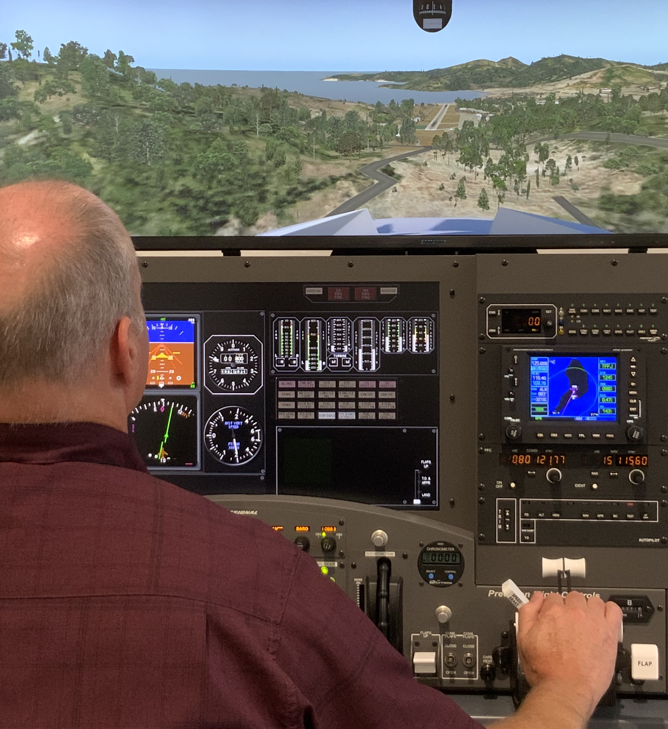 ARM Aerial Facility pilot Tim McLain makes a virtual approach to a Caribbean island runway using a flight simulator.