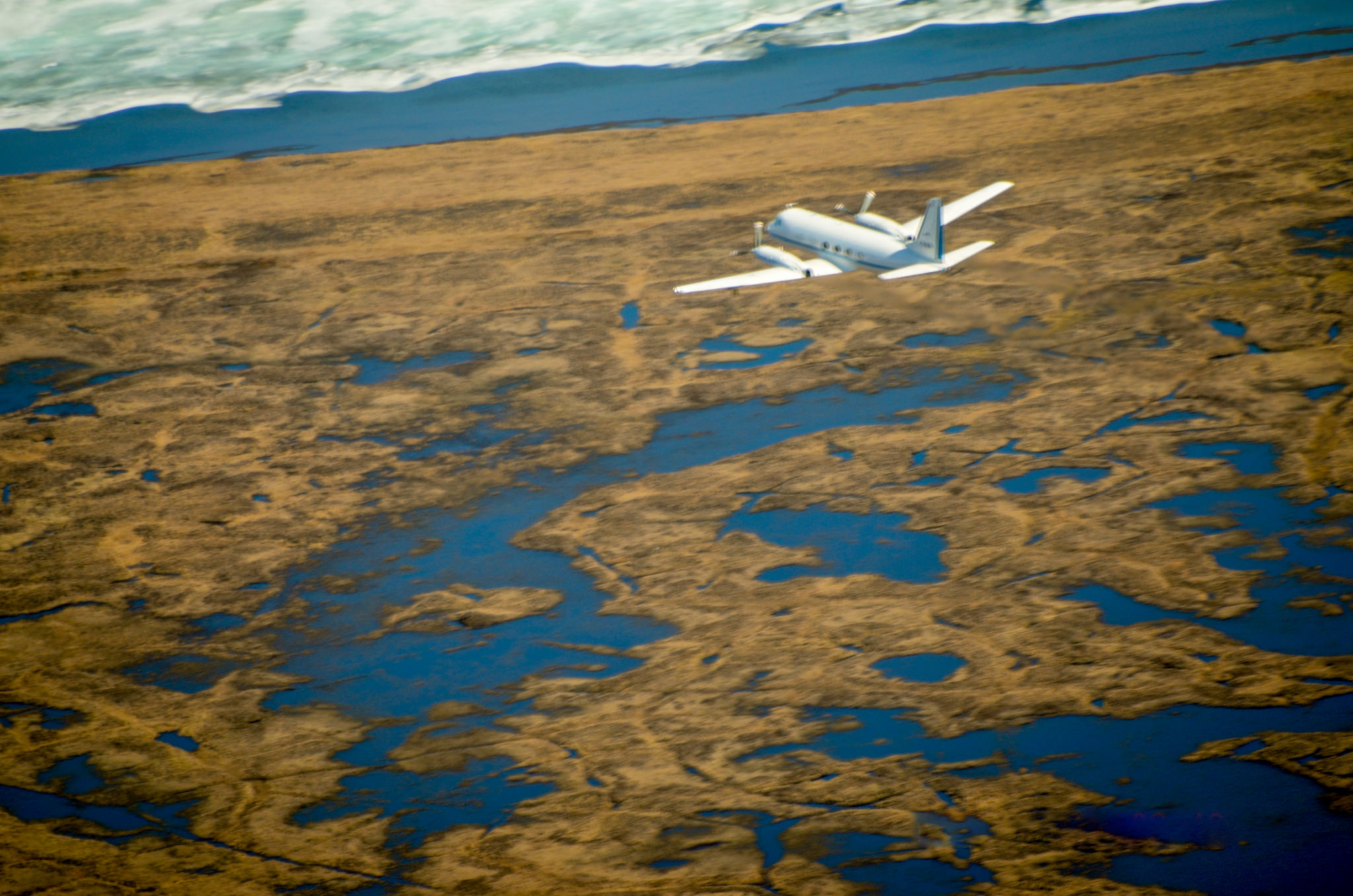 The Gulfstream-159 (G-1) research aircraft heads north towards Barrow, Alaska, in the summer of 2015, measuring trace gases above the treeless tundra and icy lakes of the Arctic. 